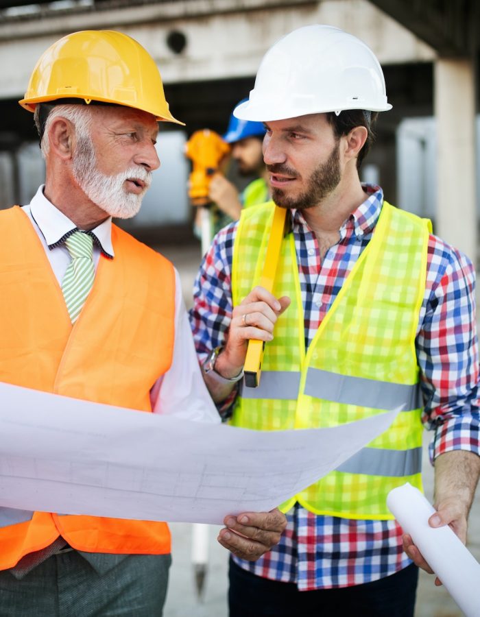 Construction engineer with foreman worker checking construction site