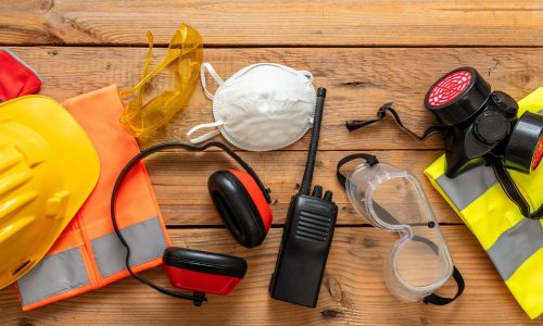 Work health and safety, Labor personal protective gear. Industry and construction site protection equipment on wooden background, banner